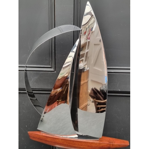 1357 - John Mellows, a metal and wood sculpture of a yacht, 82cm high.