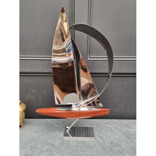 1357 - John Mellows, a metal and wood sculpture of a yacht, 82cm high.