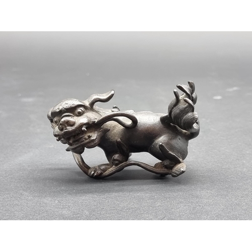 1385 - A small Chinese bronze lion dog, 8cm high; together with a small 19th century Tibetan Gau prayer box... 