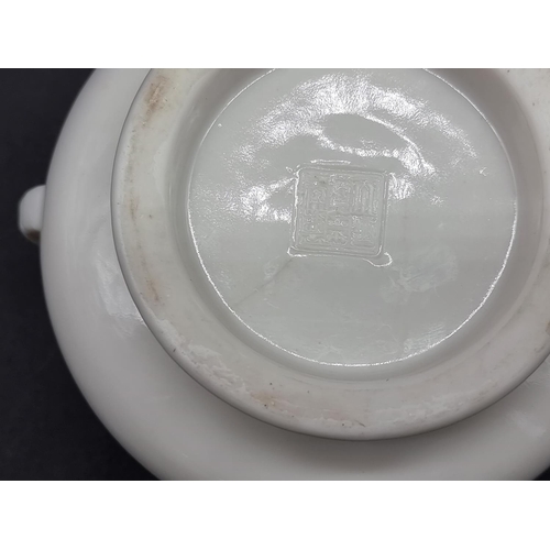 1389 - A Chinese blanc de chine twin handled censer, indistinct pressed seal mark to base, 13cm wide.... 