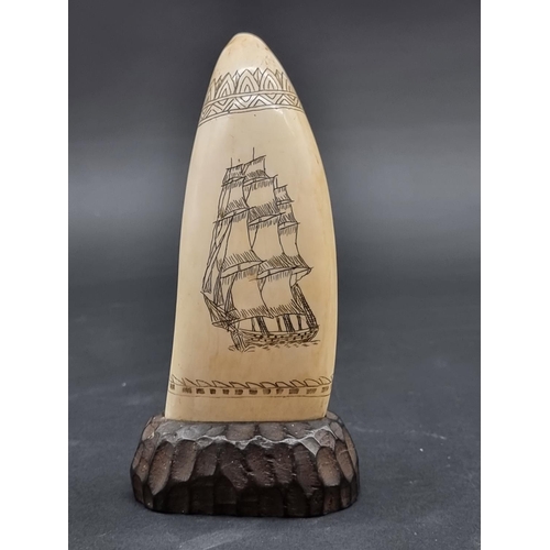 1393 - Taxidermy: a Scrimshaw carved Whale's tooth, inscribed 'The Sailors Delight', on oak base, 16.5cm hi... 