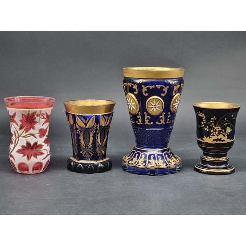 1418 - Four 19th century Bohemian glass beakers, to include a cameo example, largest 18cm high.... 