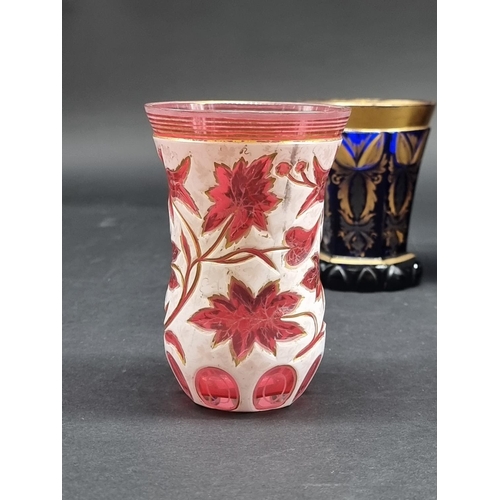 1418 - Four 19th century Bohemian glass beakers, to include a cameo example, largest 18cm high.... 