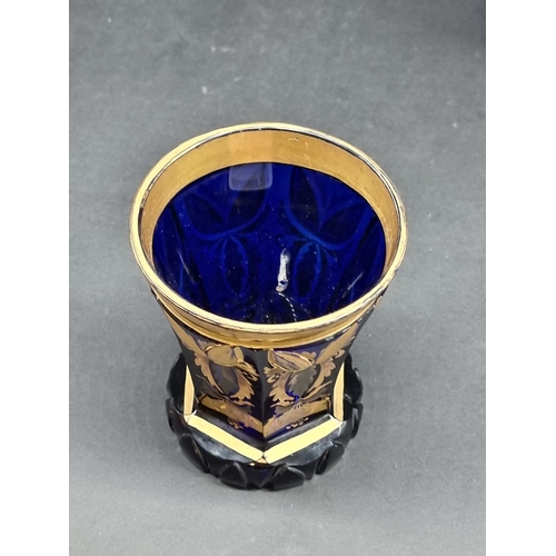 1418 - Four 19th century Bohemian glass beakers, to include a cameo example, largest 18cm high.... 