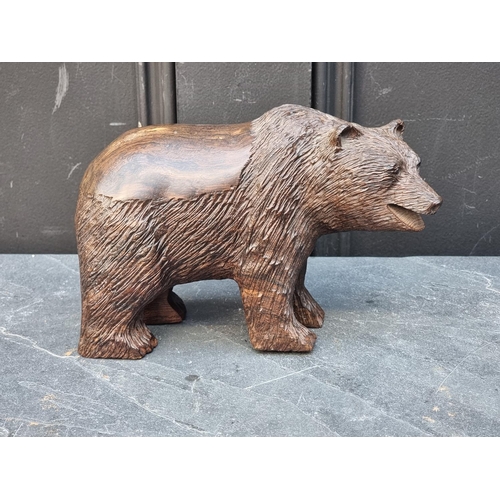 1427 - A Black Forest style carved hardwood bear, 20.5cm long.