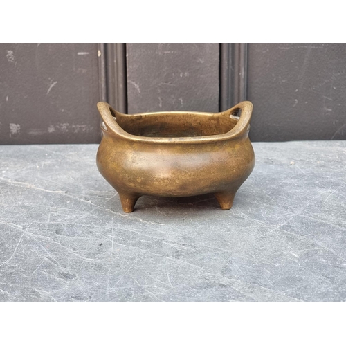 1428 - A Chinese bronze twin handled tripod censer, Xuande six character seal mark to base, 12cm diame... 