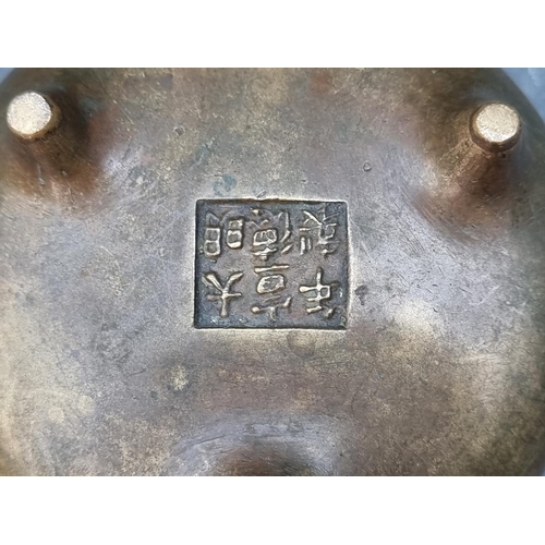 1428 - A Chinese bronze twin handled tripod censer, Xuande six character seal mark to base, 12cm diame... 