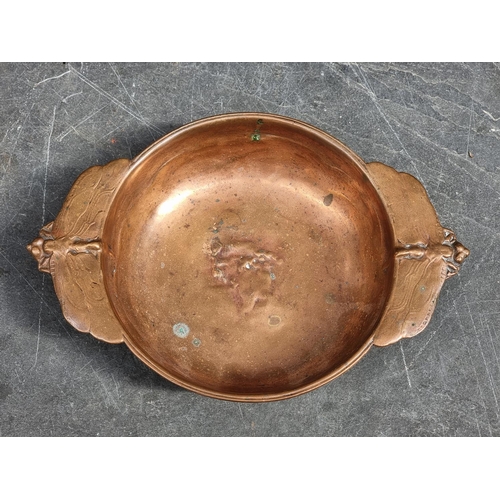 1501 - A small group of metalware, comprising: a copper twin handled bleeding bowl, decorated with two drag... 