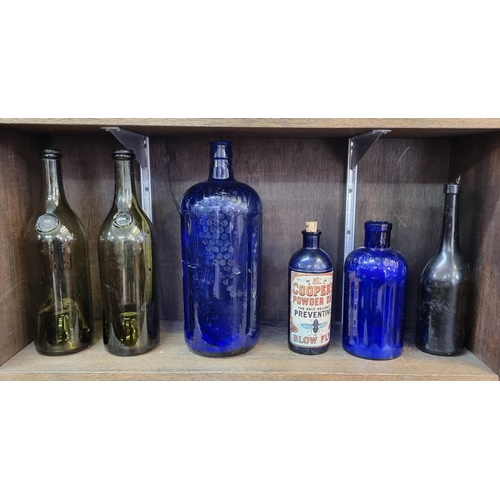 1508 - A collection of glass bottles, to include two blue glass 'Poison' examples, largest 33cm high. (7)... 