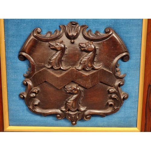 1513 - A carved oak coat of arms, by repute 'The Benne Family, Cranleigh, Surrey', in rosewood frame, the w... 