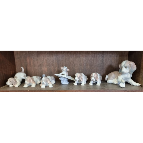 1522 - Seven Lladro dogs, largest 15cm high, (repair to one).