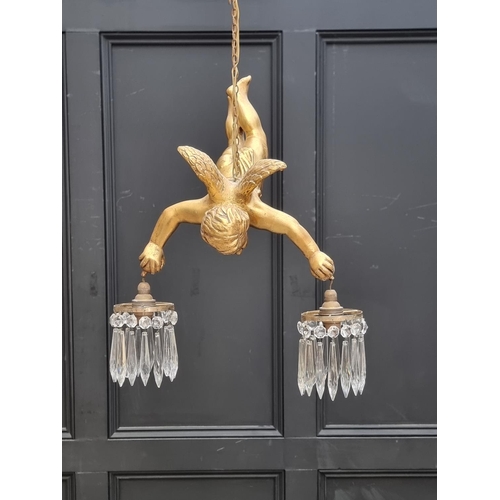 1686 - A gilt cherub twin branch ceiling light, approx. 50cm high.