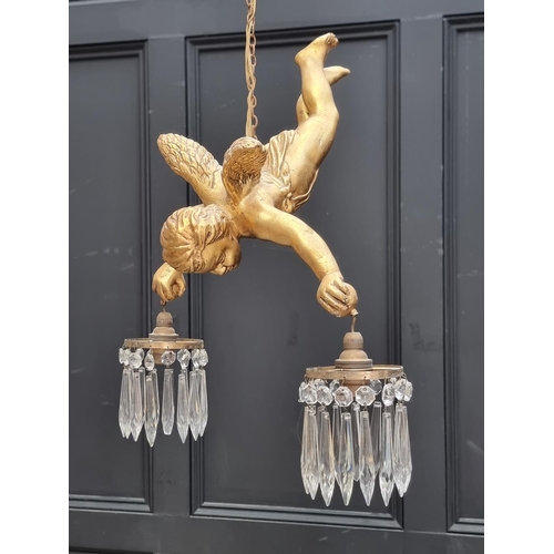 1686 - A gilt cherub twin branch ceiling light, approx. 50cm high.