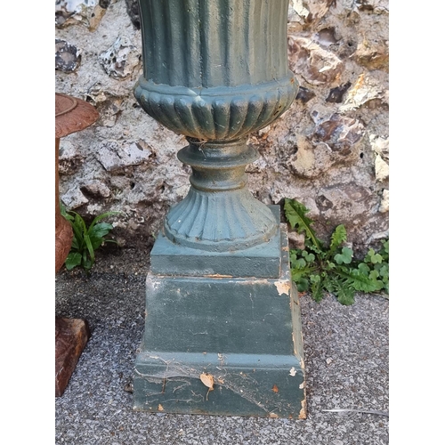 1722 - Two old cast iron Campana urns, one with plinth base, 68cm high. (2)