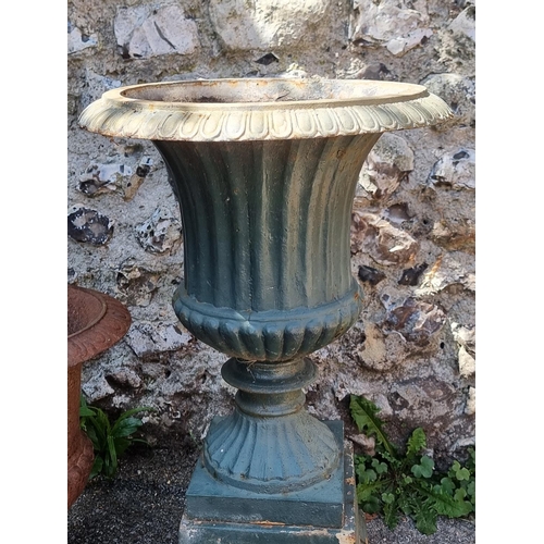 1722 - Two old cast iron Campana urns, one with plinth base, 68cm high. (2)