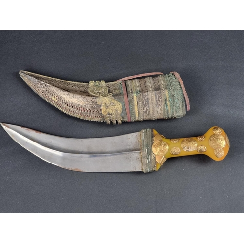 511 - An Arab jambiya and sheath, the 20cm blade with central ridge, yellow metal mounted plastic hilt, wi... 