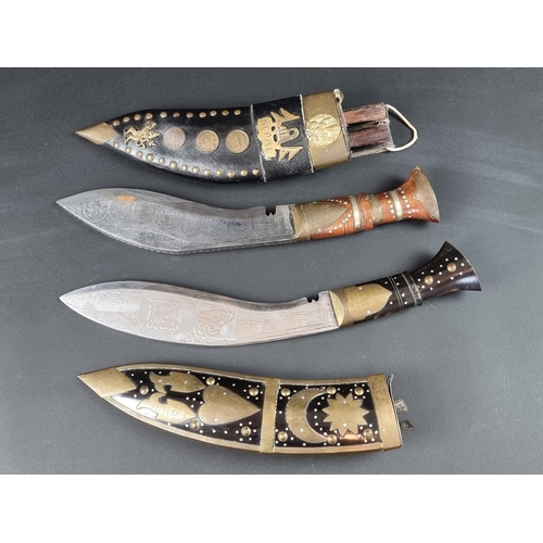 521 - A kukri and scabbard, with 22cm chased blade; together with another similar example. (2)... 