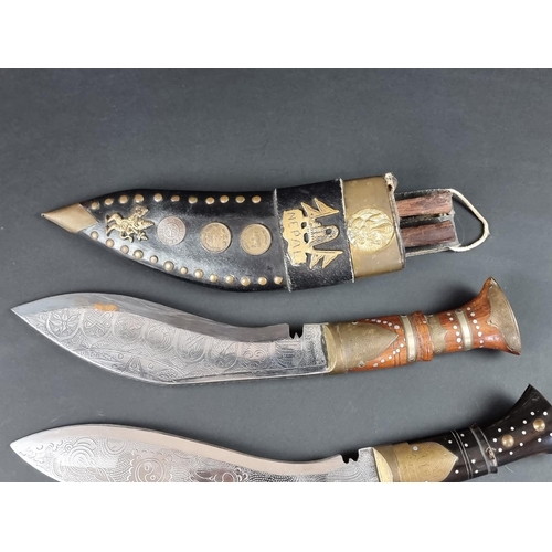 521 - A kukri and scabbard, with 22cm chased blade; together with another similar example. (2)... 