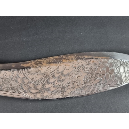 521 - A kukri and scabbard, with 22cm chased blade; together with another similar example. (2)... 