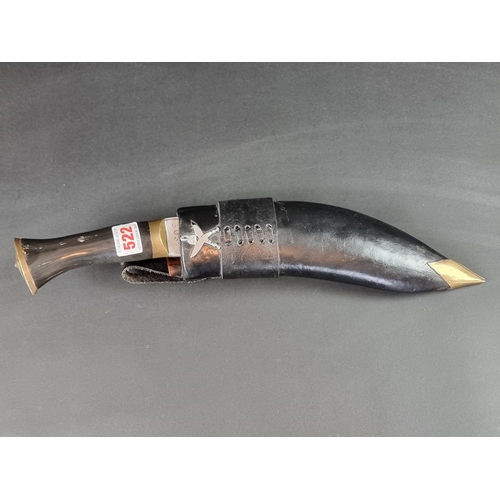 522 - A kukri and scabbard, the 16cm curved blade stamped 'Gorkha Army 3032'.