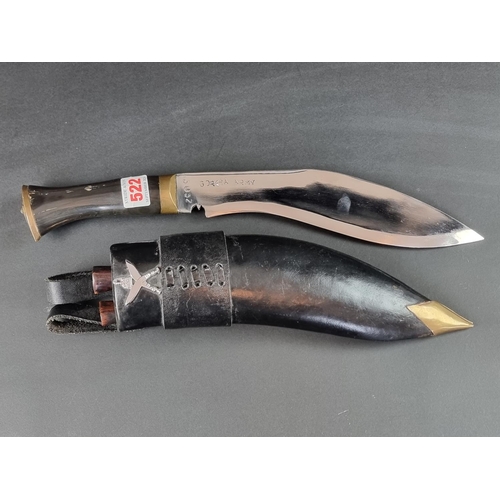 522 - A kukri and scabbard, the 16cm curved blade stamped 'Gorkha Army 3032'.