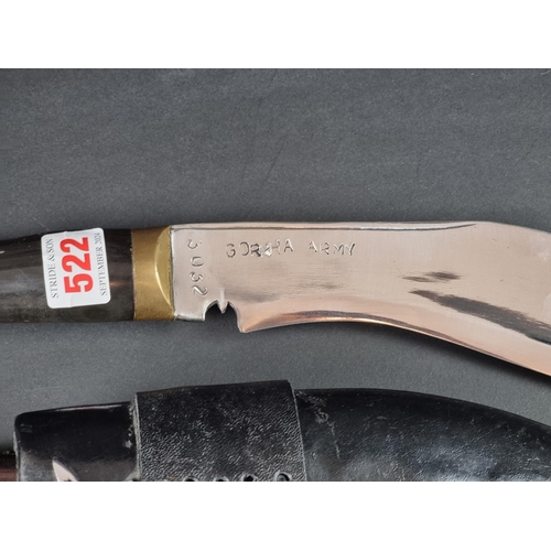 522 - A kukri and scabbard, the 16cm curved blade stamped 'Gorkha Army 3032'.