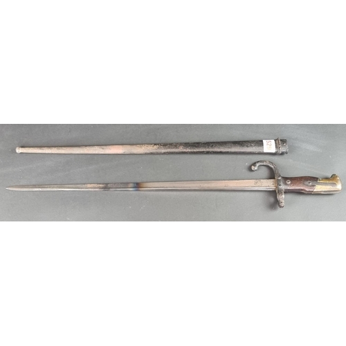 529 - A French M1874 gras bayonet and scabbard, inscribed 'St Etienne 1880'.