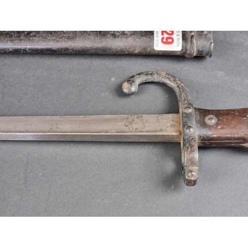 529 - A French M1874 gras bayonet and scabbard, inscribed 'St Etienne 1880'.