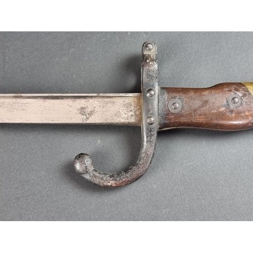 529 - A French M1874 gras bayonet and scabbard, inscribed 'St Etienne 1880'.