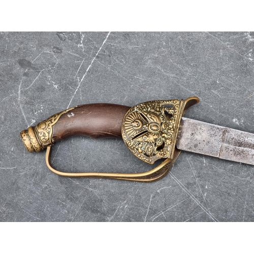 535 - A Turkish Ottoman Empire sword and scabbard, having 84cm curved blade, with brass guard and wooden g... 