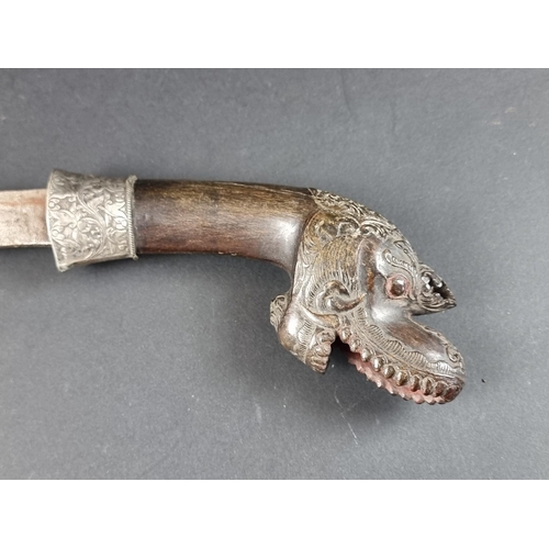 559 - A 19th century Indonesian parang and scabbard, with 32.5cm blade, carved wood Dragon's head pommel a... 