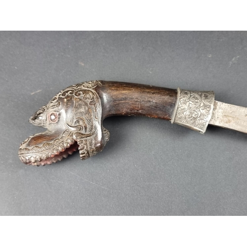 559 - A 19th century Indonesian parang and scabbard, with 32.5cm blade, carved wood Dragon's head pommel a... 