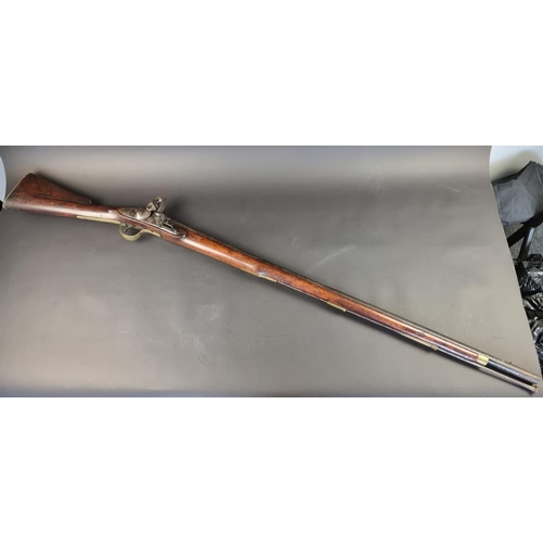 562 - A late 18th/early 19th century 'Brown Bess' flintlock trade musket, lock plate stamped 'Warranted' a... 