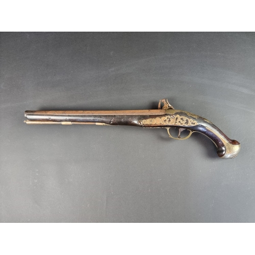 564 - An 18th century brass mounted flintlock pistol, possibly Spanish, with some residual silver plating,... 