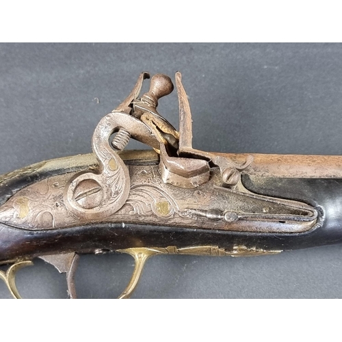 564 - An 18th century brass mounted flintlock pistol, possibly Spanish, with some residual silver plating,... 