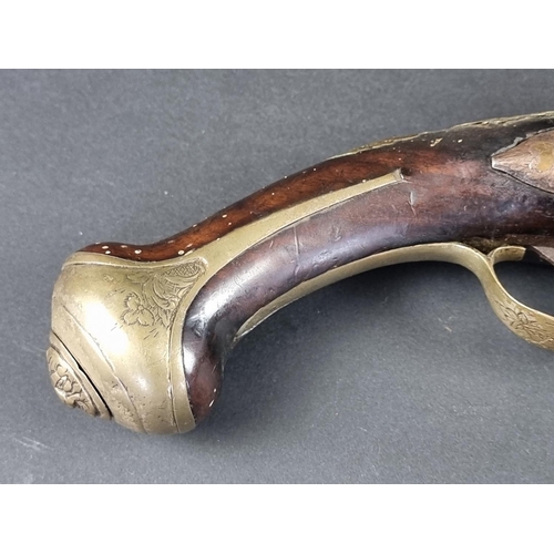 564 - An 18th century brass mounted flintlock pistol, possibly Spanish, with some residual silver plating,... 