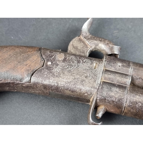 567 - A 19th century double barrelled turnover percussion pistol, with folding trigger and top strap safet... 