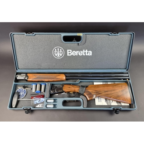 575 - A Beretta 682 gold over and under 12 bore shotgun, in original case, with five chokes, tools, snap c... 