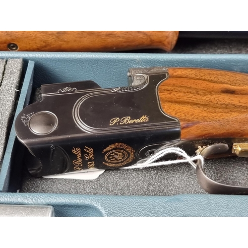 575 - A Beretta 682 gold over and under 12 bore shotgun, in original case, with five chokes, tools, snap c... 