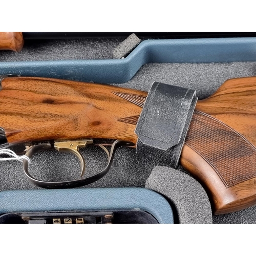 575 - A Beretta 682 gold over and under 12 bore shotgun, in original case, with five chokes, tools, snap c... 