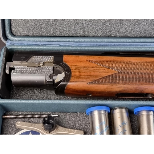 575 - A Beretta 682 gold over and under 12 bore shotgun, in original case, with five chokes, tools, snap c... 