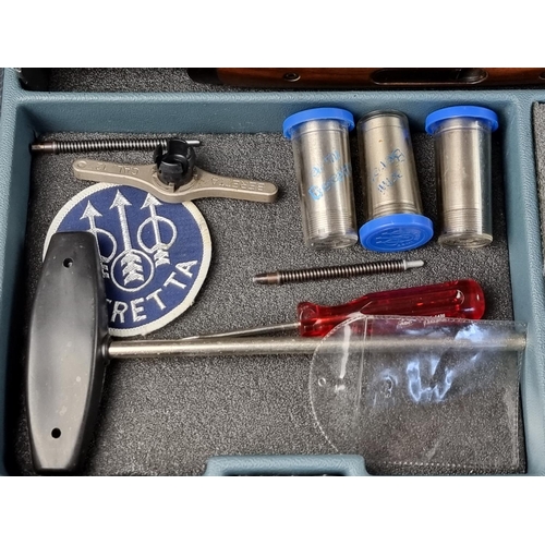 575 - A Beretta 682 gold over and under 12 bore shotgun, in original case, with five chokes, tools, snap c... 