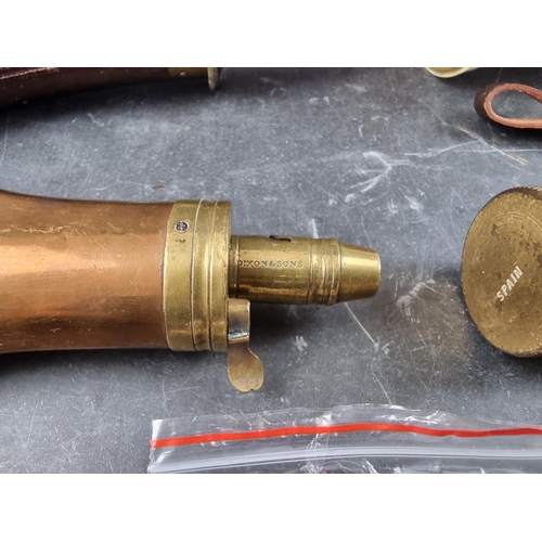 723 - A copper and brass powder flask, stamped Dixon & Sons, 20cm; together with another brown leather... 