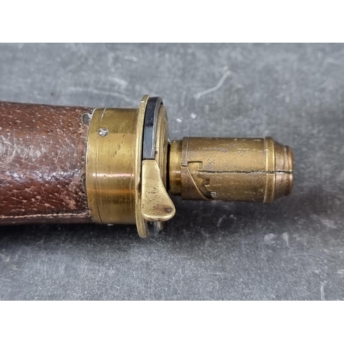 723 - A copper and brass powder flask, stamped Dixon & Sons, 20cm; together with another brown leather... 