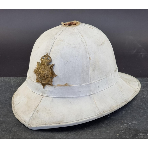 724 - A vintage South African police pith helmet. (a.f.).