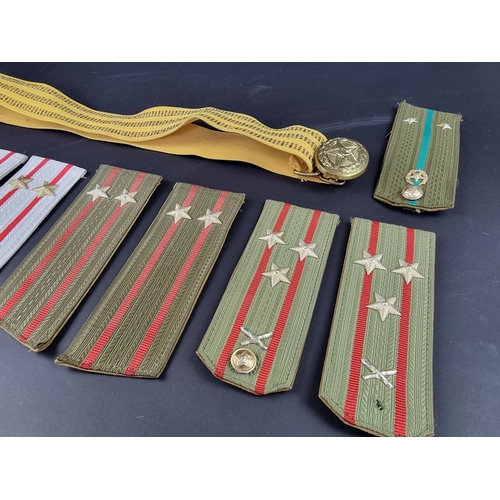 728 - A small collection of Soviet epaulettes and a belt.