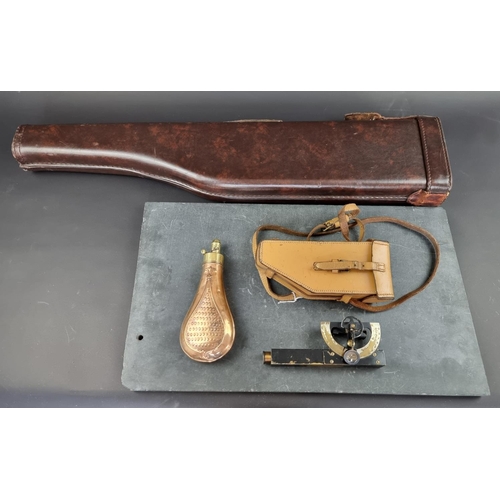 734 - A copper and brass powder flask, 20cm; together with a leg of mutton gun case; and a cased clinomete... 