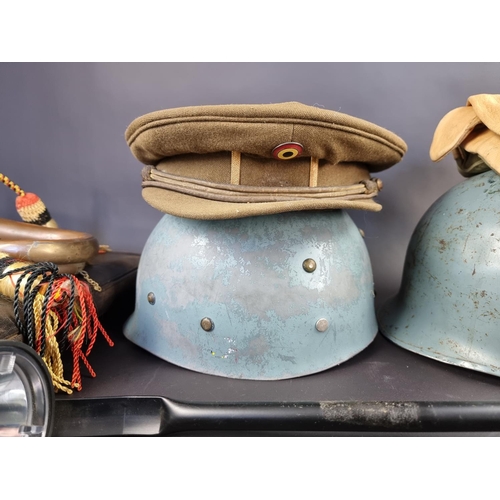 736 - A quantity of militaria, to include a helmet and a pair of leather cavalry gaiters.