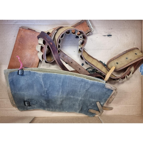 736 - A quantity of militaria, to include a helmet and a pair of leather cavalry gaiters.