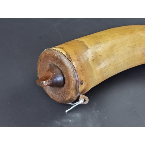 741 - A brass and wood mounted powder horn, 29cm.